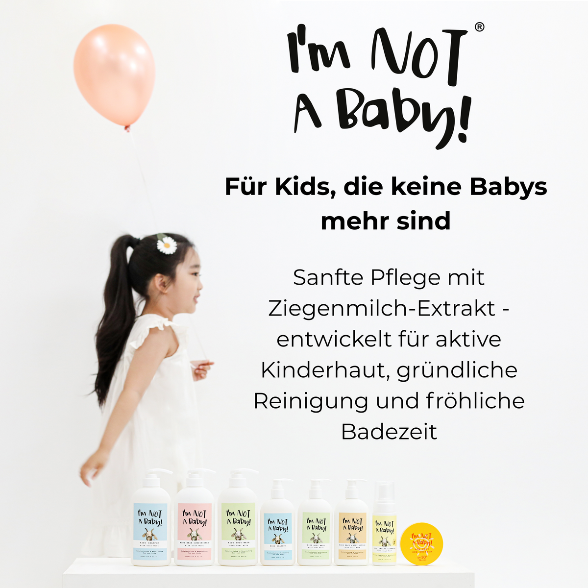 I'm NOT A Baby! Markenübersicht mit Mädchen im weißen Kleid, rosafarbenem Luftballon und Kinderpflegeprodukten mit Ziegenmilch-Extrakt auf weißem Hintergrund.